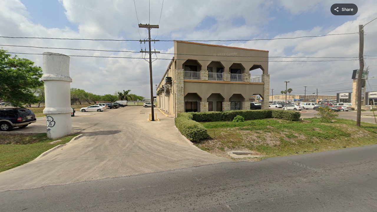 Street view of Decision Science Corp Brownsville office - two-story building with arched facade on Ruben M. Torres Blvd