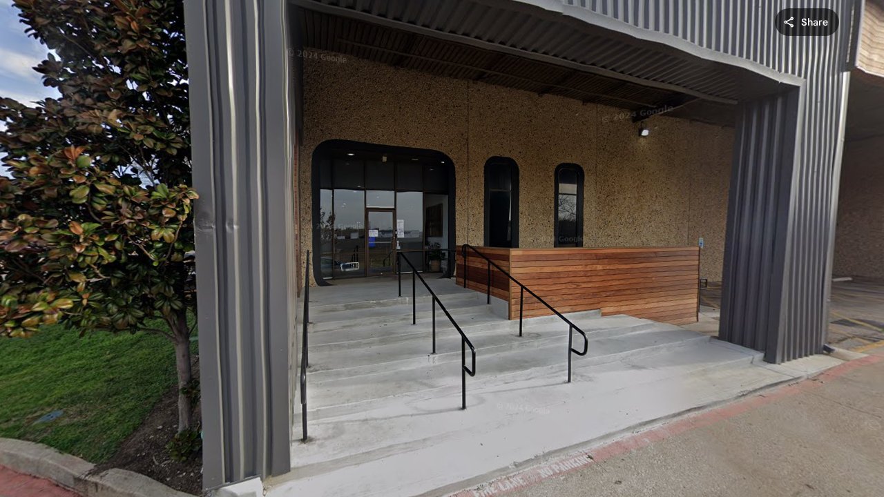 Street view of Decision Science Corp Richardson office - modern industrial building with arched windows on Jay El Drive